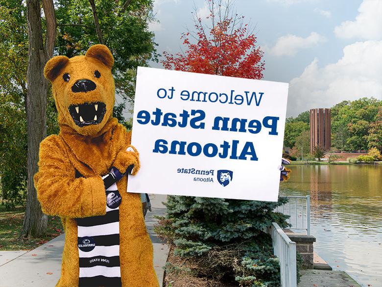 The Nittany Lion mascot holding up a sign reading Welcome to Penn State Altoona